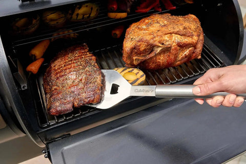 Grilling meat with Deluxe 20-Piece BBQ Tool Set With Stainless Steel Grilling Tools And Aluminum Case Includes Spatula.