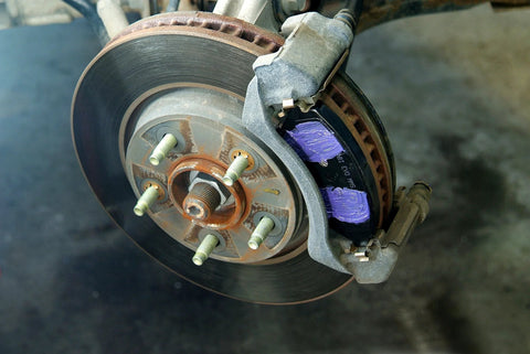 Permatex Ceramic Extreme Brake Parts Lubricant 8 oz; automotive brake rotor and caliper with purple brake pads