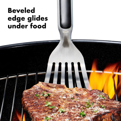 Grilling Tool Precision Turner For Effortless Burger Flips And Flaky Fish Fillets With Thin Beveled Head Non Slip Grip And Hanging Ring OXO Good Grips Black lifting steak on grill