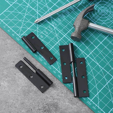 Two Pack 2.5 Inch Detachable Iron Barn Door Hinges in black, shown with tools on a cutting mat, for cabinet doors and gates.