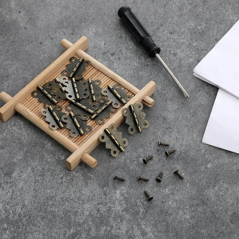 12Pcs Antique Bronze Butterfly Hinges 0.79 x 0.67 Inch With 48 Screws on a wooden tray for jewelry boxes and DIY crafts