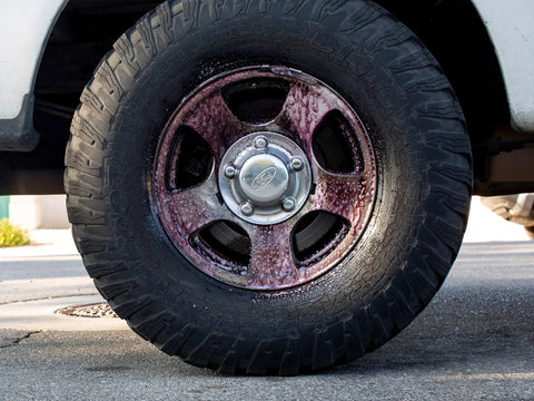 Fast Acting All Wheel Cleaner That Destroys Brake Dust, Turns Purple While Dissolving Grime, Safe For All Wheel Finishes And Brakes, Acid Free And PH Balanced Meguiars on a tire wheel.