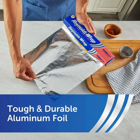 Person holding Everyday Strength Aluminum Foil Roll For Freezer And Grill Safe Cooking, 12 Inch Wide By 200 Feet Long