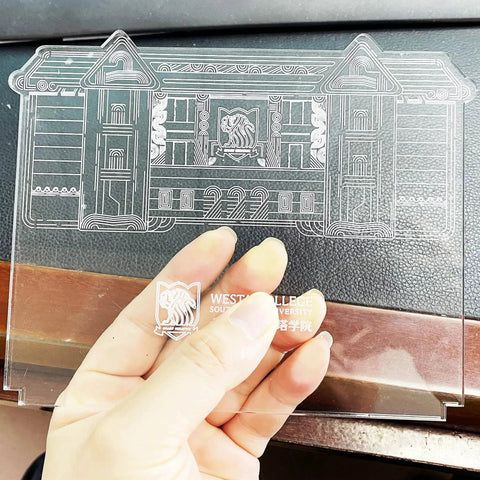 Close-up of a transparent 4mm thick acrylic sheet with etched design, part of the Clear Cast Acrylic Sheets 4mm Thick Pack of 12 for DIY Laser Cutting Engraving and LED Light Base Panels 5.9 by 5.1 Inches Square Transparent PMMA Blanks with Protective Film.