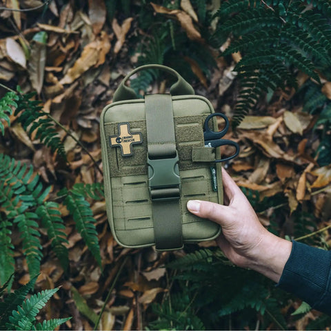 Survival First Aid Kit With Molle Pouch Emergency Medical Gear for Vehicles Car Camping Hiking Outdoors IFAK, held in hand