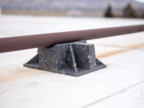 Close-up of Saddle Support Rooftop Pipe Stand Go To For Gas Piping And Electrical Conduit Pipe Cradle Sleeper Curb on roof