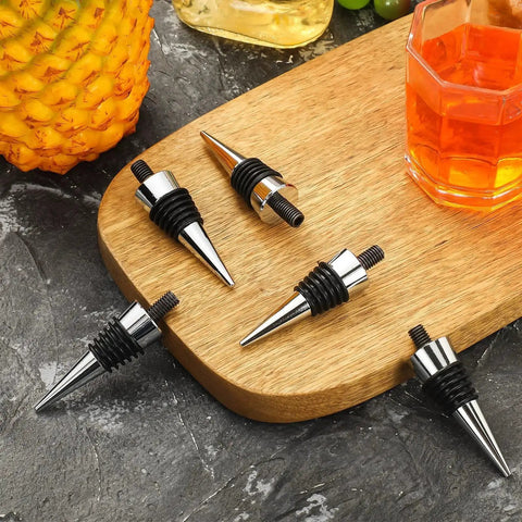 8 Piece Metal Bottle Stopper Kit With Stainless Steel Inserts Reusable Wine Saver on wooden board