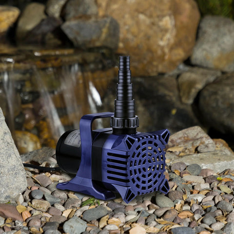 Alpine Corporation submersible water pump with blue housing and black motor on rocky ground beside a waterfall.