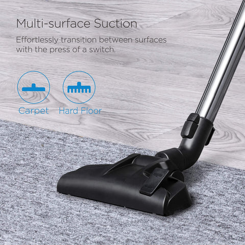 Eureka bagless canister vacuum cleaner; black floor nozzle with chrome wand on gray carpet