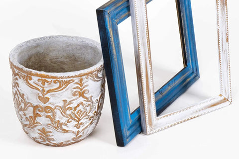 Gilding Wax King Gold Metallic Paste on ornate pot and blue picture frames, showcasing gold leaf-like finish.