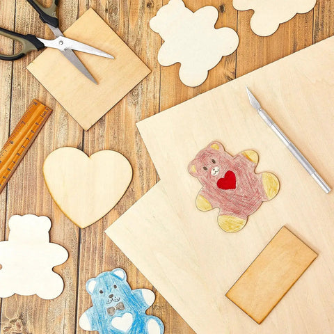 Basswood Craft Sheets Set, 12 Pieces 12 By 18 Inch Unfinished Wood Panels, 3mm Thick with drawn shapes on a table