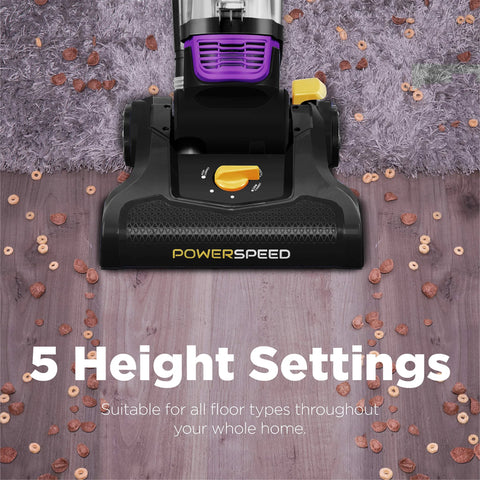 PowerSpeed bagless upright vacuum cleaner head in black with purple dust bin and yellow height knob on wood floor.