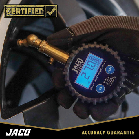 JACO Elite digital tire pressure gauge with brass body and blue LCD display showing 21.0 psi.