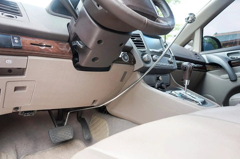 Wingbrake-V driver training brake installed in car; metal cable spans console toward steering wheel.