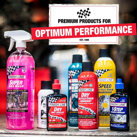 Assorted bike lubricant and cleaning products displayed on a shelf with a focus on premium performance branding