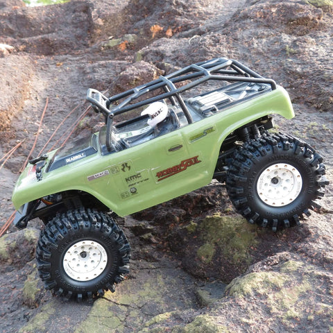 RC car on rocky terrain with 1.0 Crawler Tires 58mm Tall 1.0 Inch Mud Slingers Soft Sticky Compound For RC 1/24 SCX24 And 1/18 TRX4M Upgrades