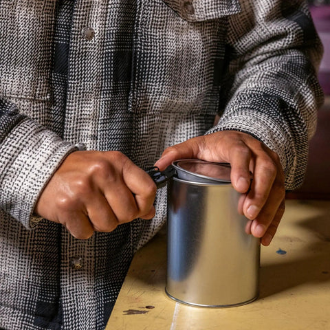 Person using Prybrid 8 In 1 Multi Tool Knife With Wire Stripper Bottle Opener Pocket Clip to open a can on a table