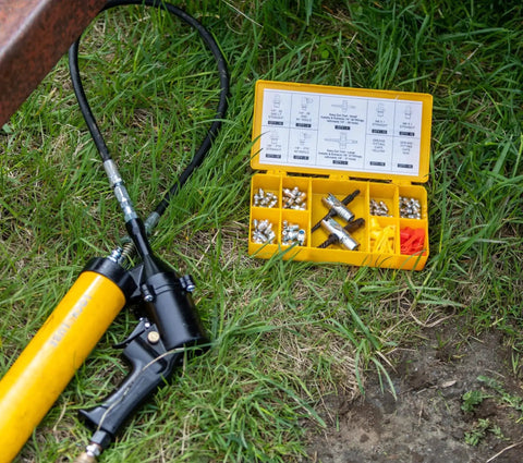 Grease Fitting Multi Tool For Easy Install And Extraction, large size, with grease fittings and hose on grass, LockNLube compatible