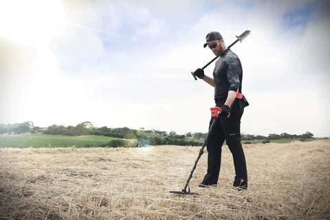 Person using Vanquish 440 Multi Frequency Metal Detector With Multi IQ Technology For All Metals in a field