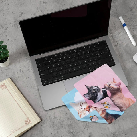 Cute Cat Microfiber Cleaning Cloths 6 Pack For Glasses Phones Screens Cameras next to a laptop and notebook on a desk