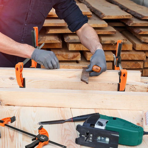 Mr. Pen 6-inch orange bar clamps (2-pack) securing a wooden board; worker in gloves, power tool nearby.