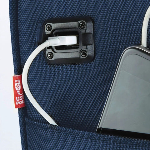 Close-up of USB charging port on navy blue smart underseat carry-on luggage.
