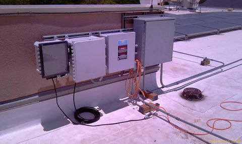 Rugged Polycarbonate Enclosure With Hinged Locking Opaque Cover, 24 x 24 x 10 Inches, installed on rooftop for solar setup