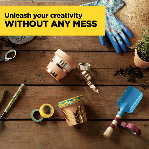 Gardening tools on wooden table with gold glitter washi tape rolls, tropical-themed pots, and blue shovel, showcasing DIY creativity.