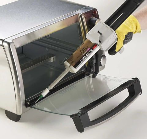 Applying 3M Scotch-Weld Clear Epoxy Adhesive DP100 Plus to an appliance glass door with a dispensing tool.