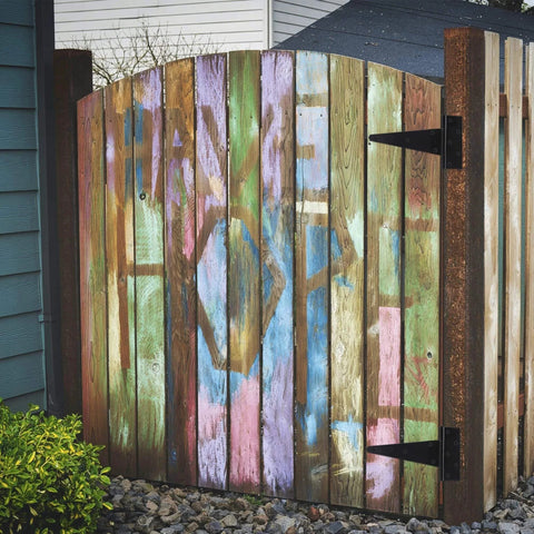 Wooden fence gate with colorful graffiti featuring 10 Inch T Strap Heavy Duty Door Hinges Black Tee Hinge For Wood Fences Gardens Barn