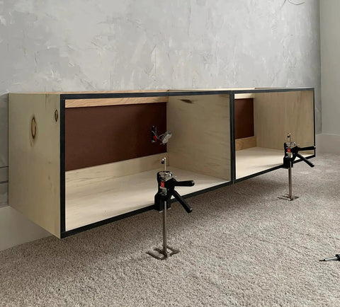 Original Handheld Jack and Clamp for One Hand Lifting Up to 330 Lbs installed under wooden cabinets on carpeted floor