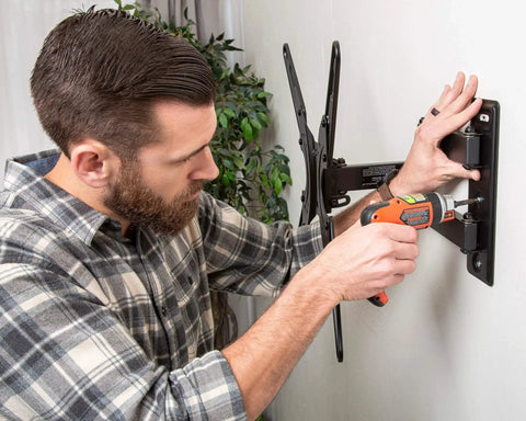 Man installing TV mount on wall using SnapToggle Be Toggle Anchor Zinc Plated Steel Channel For 3/8 To 2-1/2 Grip Range In Hollow Walls For 5/16-18 UNC Fasteners Pack Of 25 With Easy One Person Installation Behind Gypsum Board Drywall Concrete Block Ideal For Secure Mounting In Residential.