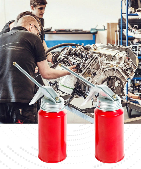 Two Pack 200ml Oil Can Sprayer Set With Manual Pump Oiler And Nozzle shown near automotive engine in workshop, red metal body