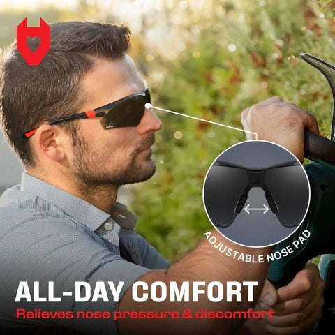 Person wearing green tinted wraparound safety glasses with adjustable arms, highlighted no slip grips, for all-day comfort and impact protection