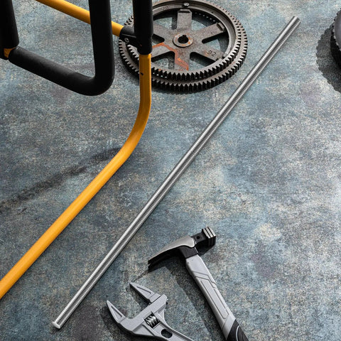 Four Piece Half Inch Fully Threaded Rods 36 Inch 304 Stainless Right Threads shown with tools and gears on a workshop floor.