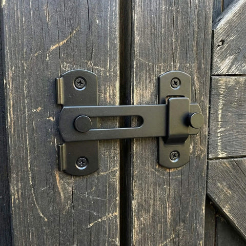 Barn Door Lock Set With Sliding Door Hardware In Carbon Steel Black Finish installed on a wooden barn door
