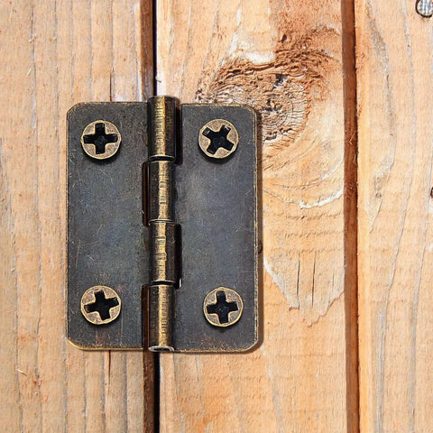 Two Size Bronze Mini Hinge Set With 60 Small Hinges And 300 7 Mm Screws In Clear Storage Box for Dollhouse Doors Cabinets Crafts Wooden Jewelry Boxes and Outdoor Decor Totally DIY Ready installed on wood surface.