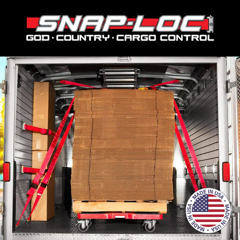 Snap-Loc cargo control in trailer with stacked cardboard secured by red straps, featuring made in USA logo, view from rear.