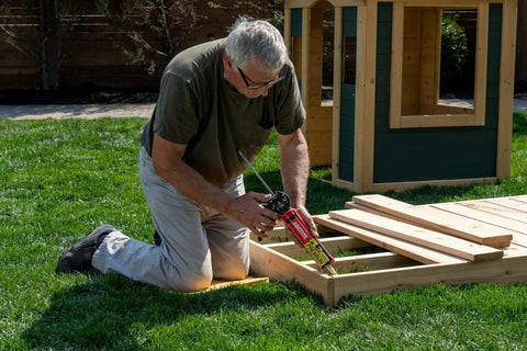 Man applying Tough As Nails Durable Polyurethane Construction Adhesive For Wood Concrete Stone And Metal outdoors