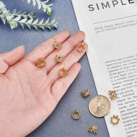 Golden Crown Beads Set 11x7mm Large Hole Crystal Cubic Zirconia Pave King Crown Charms displayed on a hand and surface.
