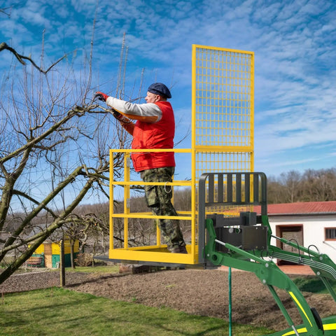 Person on Heavy Duty Forklift Safety Cage 1400 Lb Work Platform Guard Rails Collapsible using it for tree trimming