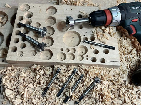 Forstner Bit Set 16 Piece Hex Shank Wood Drill Bits Kit For Flat Bottom Holes displayed with wood shavings and drill