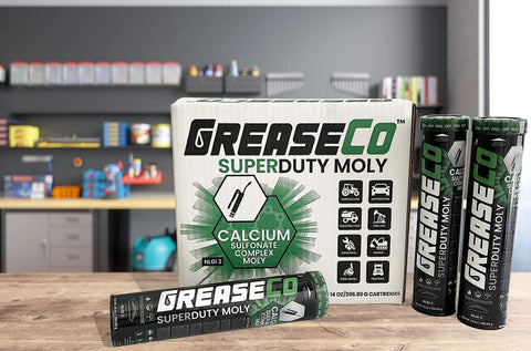 Extreme Duty Moly Grease For Fifth Wheel And Ball Joints Automotive Pin And Bushing Lubricant Calcium Sulfonate Complex With Moly Disulfide NLGI Grade 2 Single Cartridge For Grease Gun shown with packaging in a garage setting