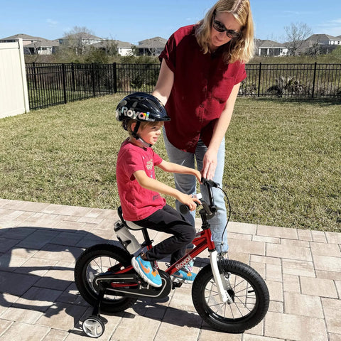 Child riding a bike with Training Wheels For 12-18 Inch Kid Friendly Bikes With Heavy Duty Steel Brackets And Quiet Rubber Tires.