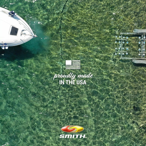 Aerial view of a boat dock with "Proudly Made in the USA" text, displaying the Smith logo, in clear green water.