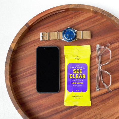 Lens Cleaning Wipes For Glasses And Screens Streak Free Scratch Free 192 Wipes next to watch, glasses, and smartphone on tray.