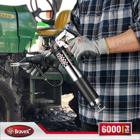 Bravex pistol-grip grease gun with 18-inch flexible hose, silver/black, 6000 PSI, used on a tractor