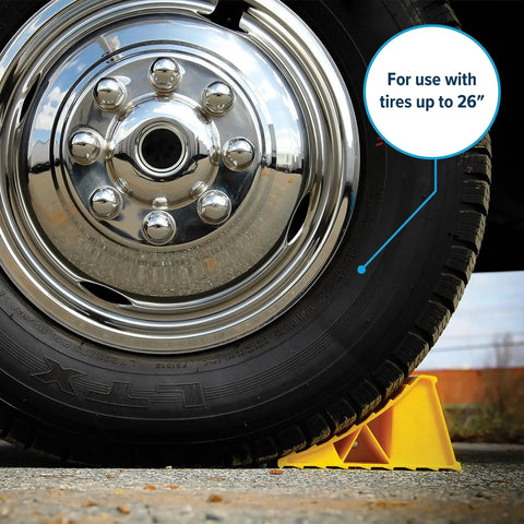 Yellow RV Wheel Chocks 2 Pack Heavy Duty Keeps Trailer In Place Up To 26 Inches under a large tire on pavement.