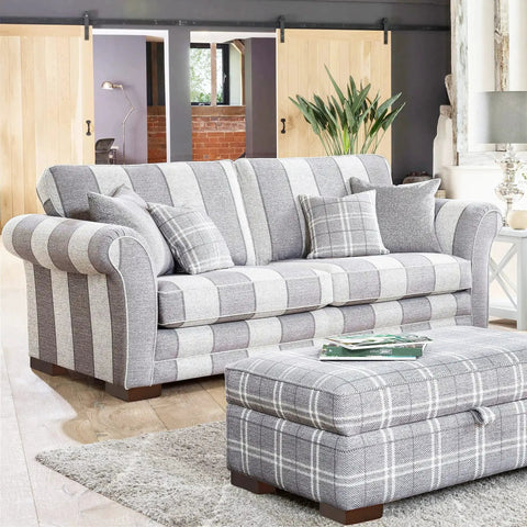 Striped sofa in living room with wooden sliding doors and solid wood furniture legs set with L shaped bed risers visible.