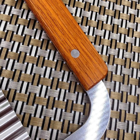 Close-up of wooden handle and stainless steel blade of Crinkle Slicer Set Of 2 For Wavy Fries And Veggies With Stainless Steel Blade And Wooden Handle From Guardians, Beast Of A Chopper For Potatoes Fruits Veggies Eggs And Fancy Garnishes.